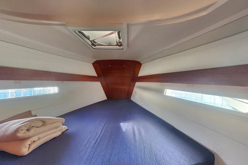  Yacht Photos Pics Cabin interior of 2015 Dufour 41.2 GL yacht with bed and portholes.