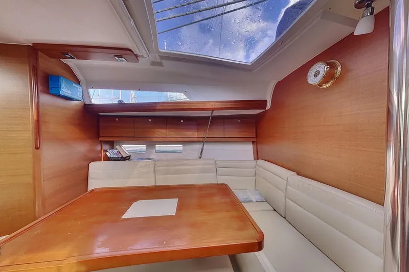  Yacht Photos Pics Interior of 2015 Dufour 41.2 GL yacht with wooden table and white seating.