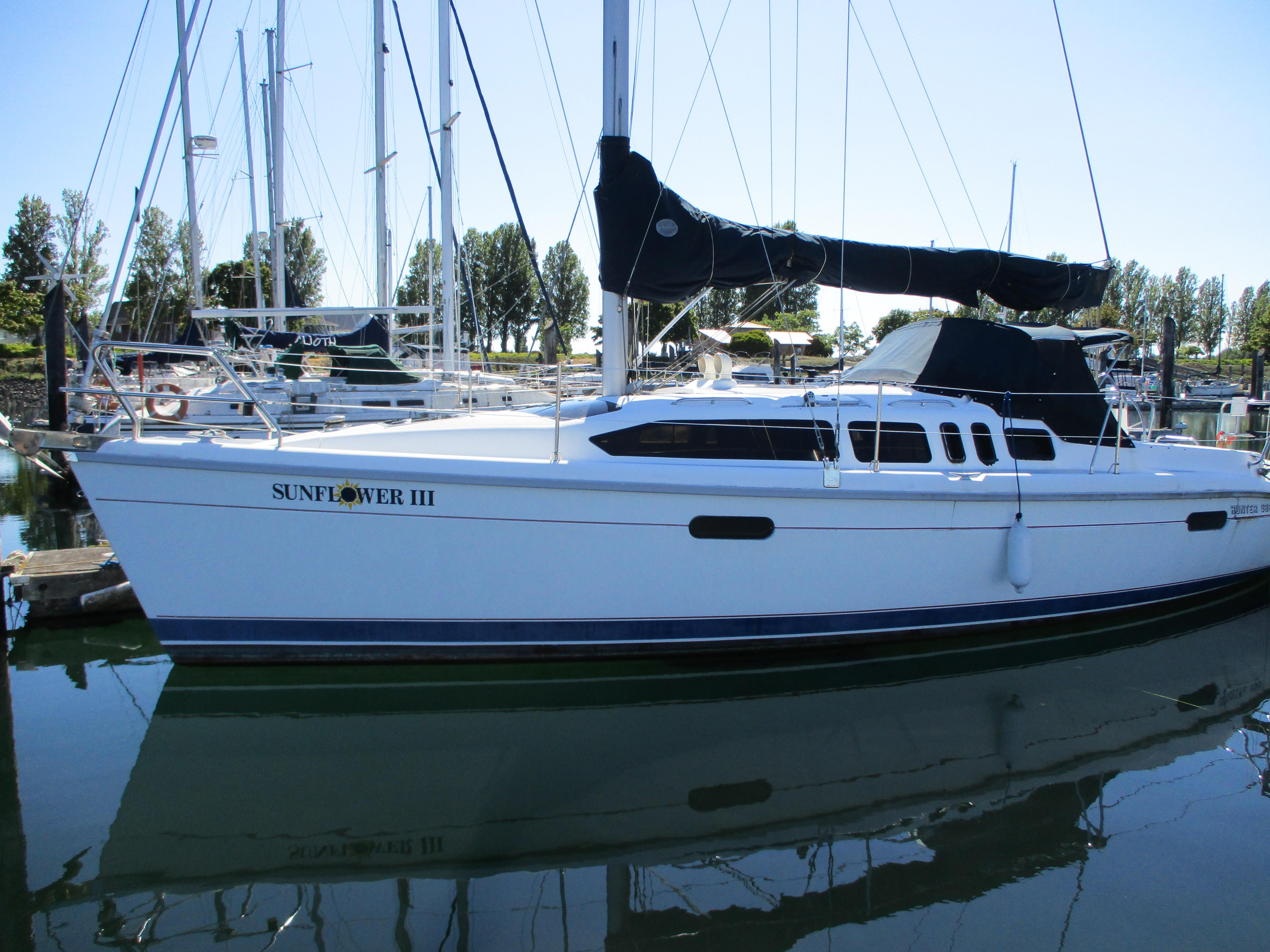 1995 Hunter 336 sailboat docked, named Sunflower III.