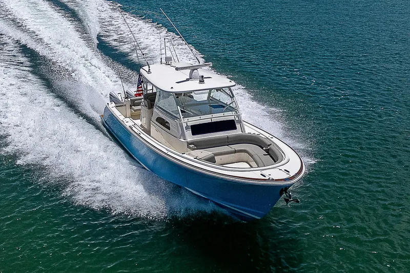 Tropical Breeze Yacht Photos Pics 2020 Hinckley Sport Boat 40 C cruising on open water, showcasing sleek design and performance.