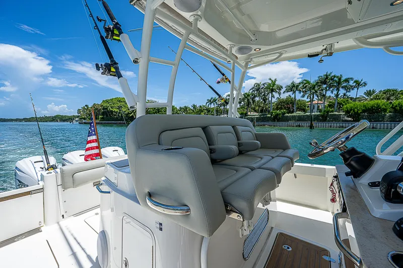 Tropical Breeze Yacht Photos Pics 2020 Hinckley Sport Boat 40 C interior with plush seating and scenic waterfront view.