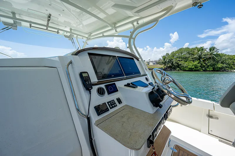 Tropical Breeze Yacht Photos Pics Helm of 2020 Hinckley Sport Boat 40 C with modern navigation equipment, on a sunny day.