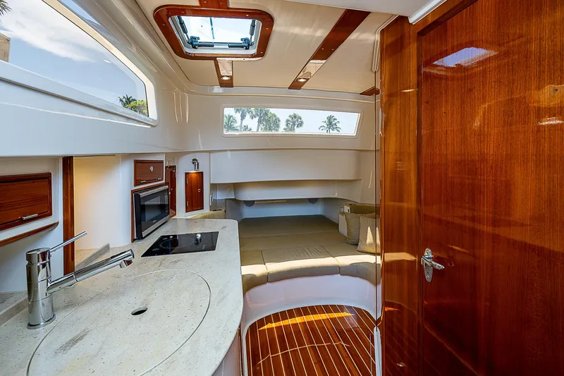 Tropical Breeze Yacht Photos Pics Interior of 2020 Hinckley Sport Boat 40 C, featuring modern kitchen and seating area.