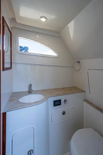 Tropical Breeze Yacht Photos Pics 2020 Hinckley Sport Boat 40 C bathroom interior with modern fixtures and natural light.
