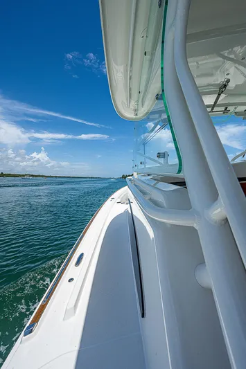 Tropical Breeze Yacht Photos Pics 2020 Hinckley Sport Boat 40 C cruising on clear blue waters under a sunny sky.