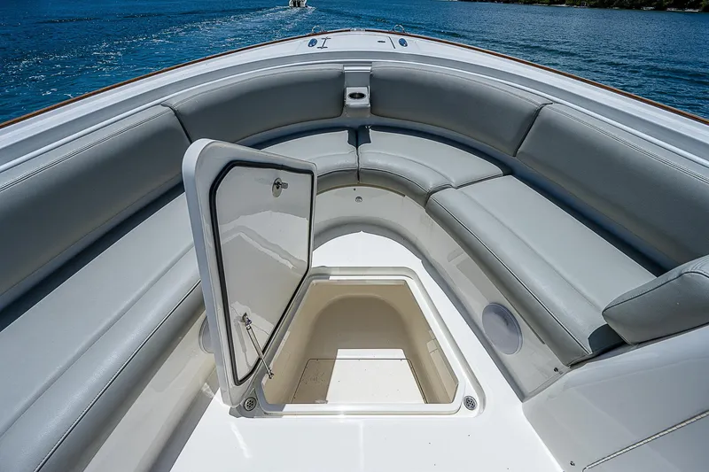 Tropical Breeze Yacht Photos Pics 2020 Hinckley Sport Boat 40 C with open storage compartment and cushioned seating.