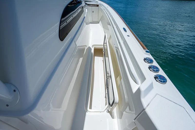 Tropical Breeze Yacht Photos Pics Hinckley Sport Boat 40 C 2020, sleek deck design, white finish, ocean backdrop.