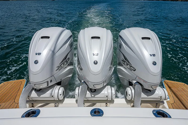 Tropical Breeze Yacht Photos Pics Triple outboard engines on a 2020 Hinckley Sport Boat 40 C cruising on water.