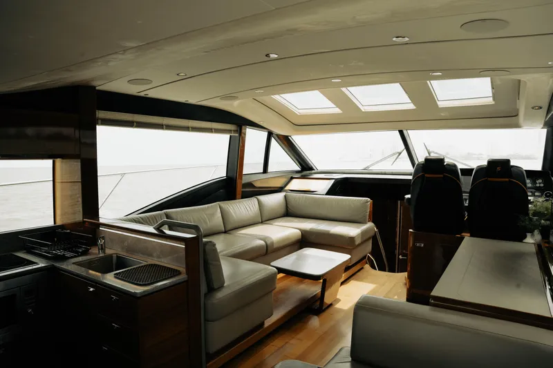 Amaray Yacht Photos Pics Luxurious interior of 2020 Princess S62 yacht with modern seating and panoramic windows.