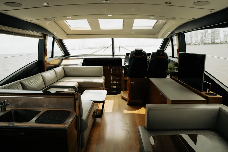 Amaray Yacht Photos Pics Luxurious interior of 2020 Princess S62 yacht with modern seating and panoramic windows.