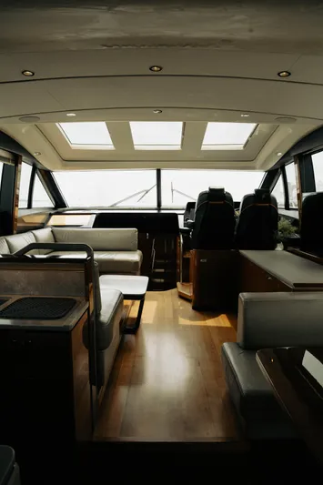 Amaray Yacht Photos Pics Luxurious interior of a 2020 Princess S62 yacht with modern seating and panoramic windows.