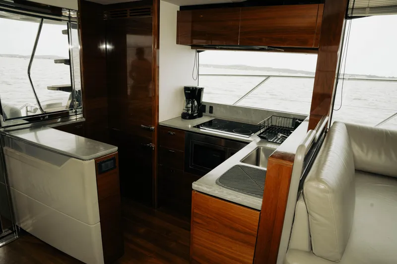 Amaray Yacht Photos Pics Luxurious kitchen interior of 2020 Princess S62 yacht with modern appliances and sleek design.