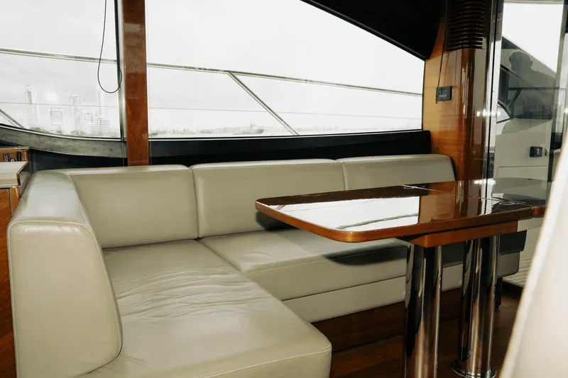Amaray Yacht Photos Pics Luxurious interior of 2020 Princess S62 yacht with elegant seating and polished wooden table.