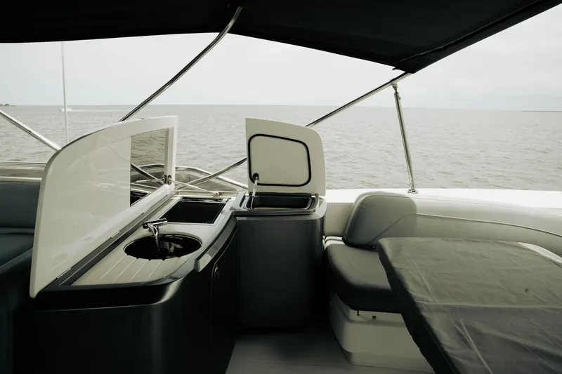 Amaray Yacht Photos Pics Luxurious 2020 Princess S62 yacht interior with kitchenette and seating, overlooking the ocean.