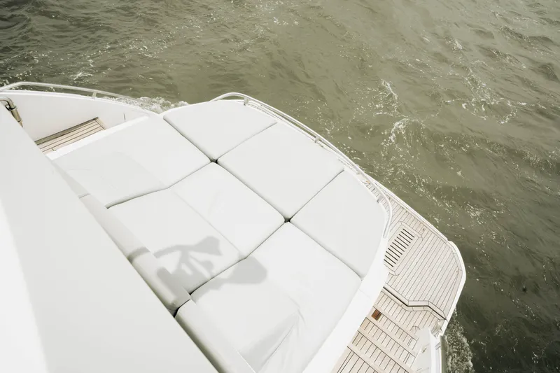 Amaray Yacht Photos Pics Luxury yacht Princess S62, 2020 model, featuring spacious sunbathing deck on calm waters.