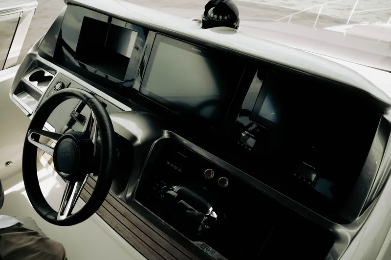 Amaray Yacht Photos Pics Helm of 2020 Princess S62 yacht with modern navigation displays and steering wheel.