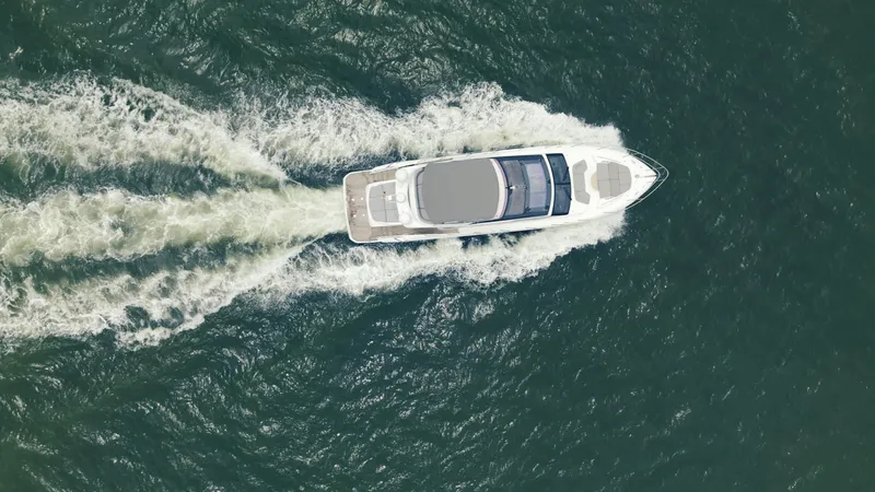 Amaray Yacht Photos Pics Aerial view of 2020 Princess S62 yacht cruising through the ocean.