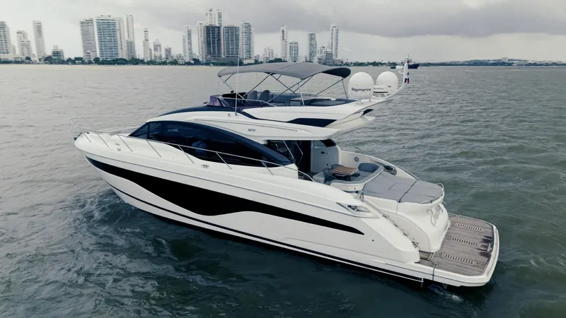 Amaray Yacht Photos Pics 2020 Princess S62 yacht cruising near city skyline on a cloudy day.