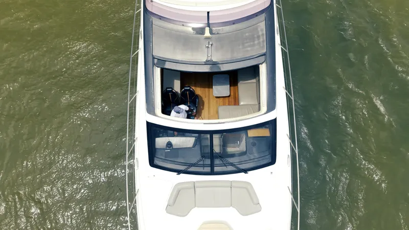 Amaray Yacht Photos Pics Aerial view of 2020 Princess S62 yacht on water, showcasing deck and seating area.