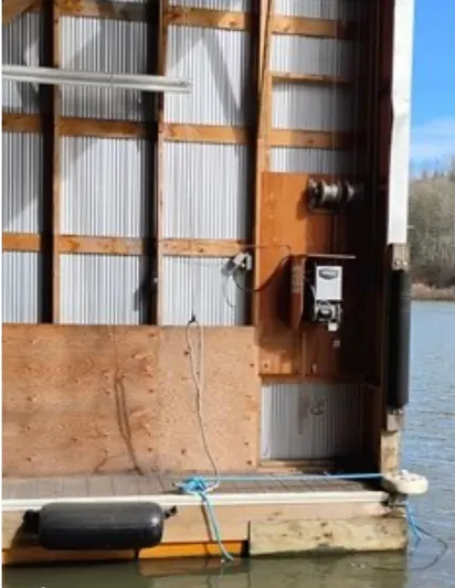  Yacht Photos Pics Custom 2012 boathouse with wooden and metal siding by a calm river.