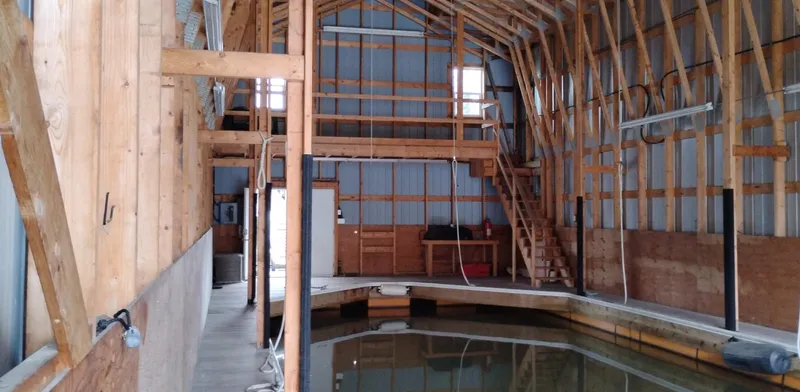  Yacht Photos Pics Interior of a custom 2012 boathouse with wooden beams and indoor water dock.