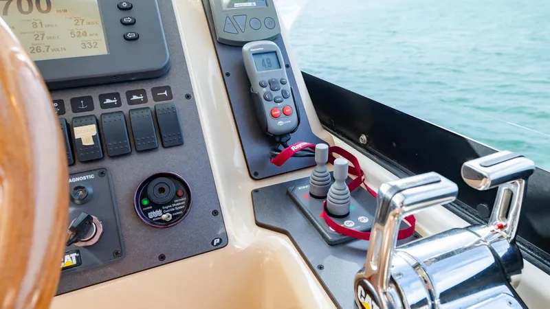Unchained Freedom Yacht Photos Pics Control panel of a 2007 Maritimo M60 Cruising Motor Yacht with throttle and navigation instruments.