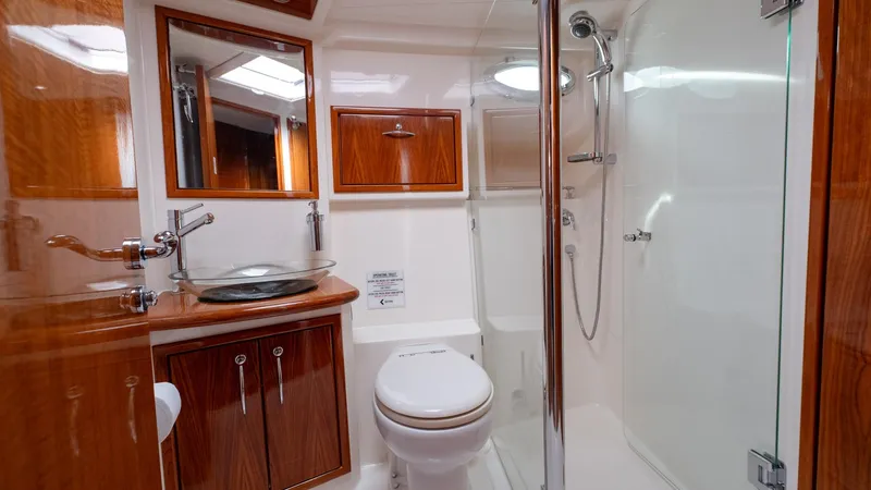 Unchained Freedom Yacht Photos Pics Luxurious bathroom in 2007 Maritimo M60 yacht with wood accents and modern fixtures.