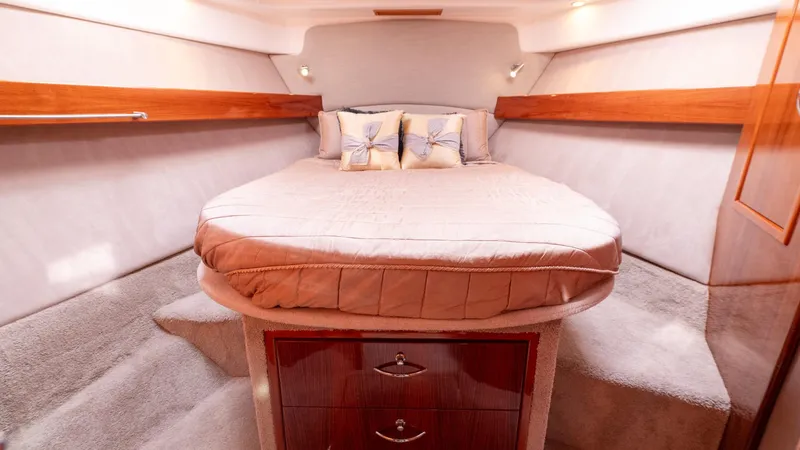 Unchained Freedom Yacht Photos Pics Luxurious bedroom in 2007 Maritimo M60 Cruising Motor Yacht with cozy bed and elegant wood accents.