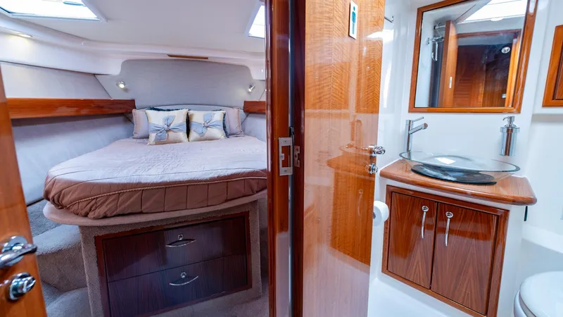 Unchained Freedom Yacht Photos Pics Luxurious 2007 Maritimo M60 yacht interior with cozy bedroom and modern bathroom.