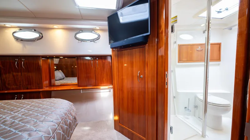 Unchained Freedom Yacht Photos Pics Luxurious cabin interior of 2007 Maritimo M60 yacht with wood finishes and ensuite bathroom.