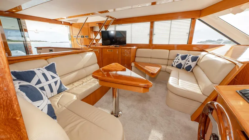 Unchained Freedom Yacht Photos Pics Luxurious interior of 2007 Maritimo M60 Cruising Motor Yacht with plush seating and elegant wood finishes.