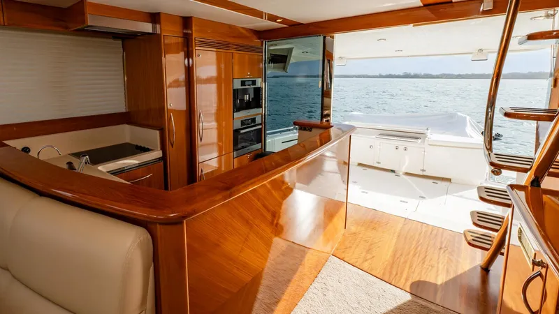 Unchained Freedom Yacht Photos Pics Luxurious interior of 2007 Maritimo M60 yacht with wood finishes and ocean view.