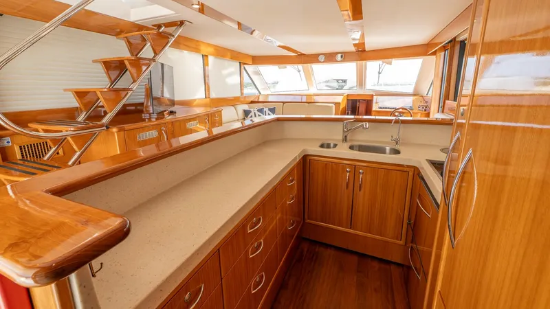 Unchained Freedom Yacht Photos Pics Luxurious kitchen interior of 2007 Maritimo M60 Cruising Motor Yacht with wooden cabinetry.