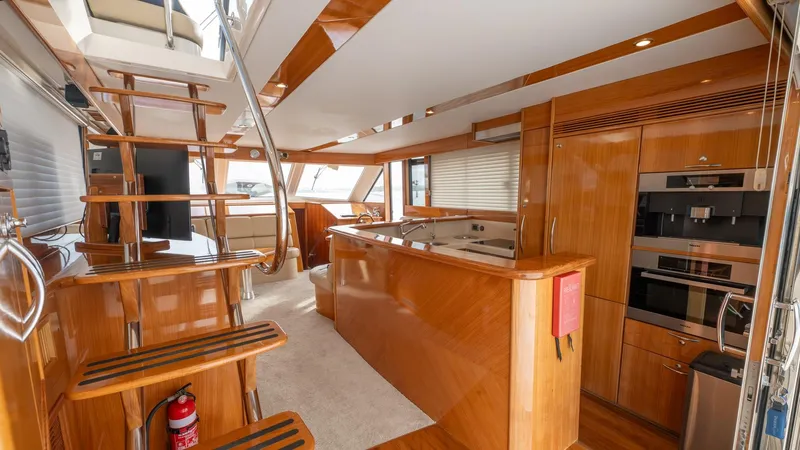 Unchained Freedom Yacht Photos Pics Luxurious interior of 2007 Maritimo M60 Cruising Motor Yacht with wooden finishes and modern amenities.