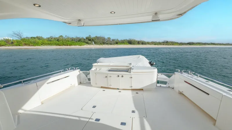 Unchained Freedom Yacht Photos Pics 2007 Maritimo M60 Cruising Motor Yacht deck with ocean view and shoreline in background.