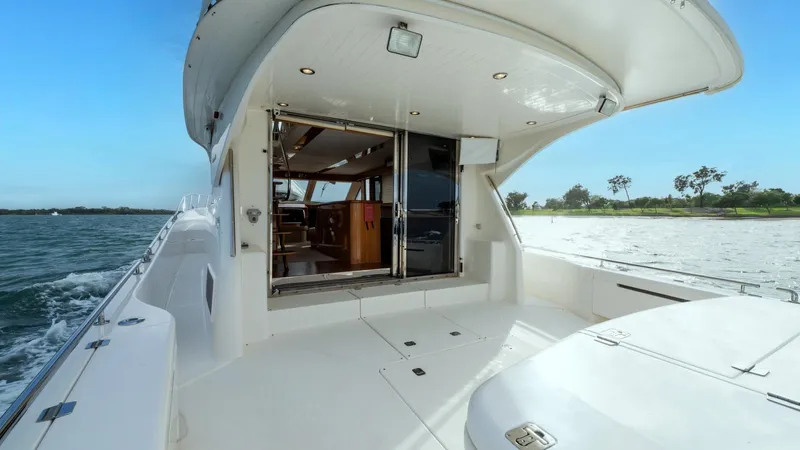 Unchained Freedom Yacht Photos Pics 2007 Maritimo M60 Cruising Motor Yacht, spacious deck with open cabin view, on calm waters.