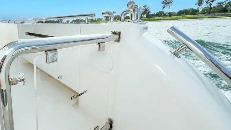 Unchained Freedom Yacht Photos Pics 2007 Maritimo M60 Cruising Motor Yacht deck with stainless steel railings and scenic water view.