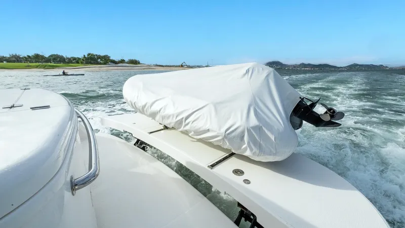 Unchained Freedom Yacht Photos Pics 2007 Maritimo M60 Cruising Motor Yacht with covered equipment, navigating near a scenic coastline.