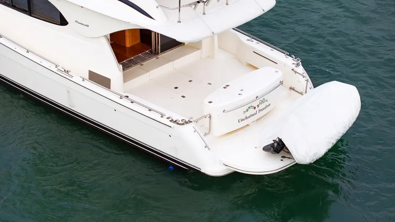 Unchained Freedom Yacht Photos Pics 2007 Maritimo M60 Cruising Motor Yacht on water, rear view with covered equipment.