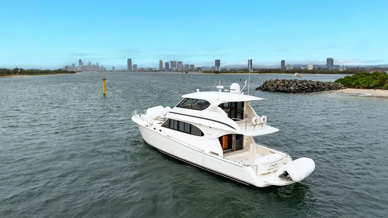 Unchained Freedom Yacht Photos Pics 2007 Maritimo M60 Cruising Motor Yacht on water, city skyline in background.