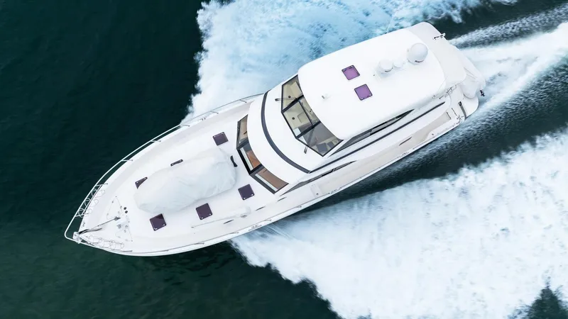 Unchained Freedom Yacht Photos Pics Aerial view of 2007 Maritimo M60 Cruising Motor Yacht navigating through water.