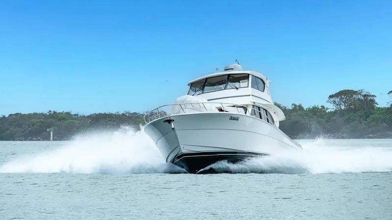 Unchained Freedom Yacht Photos Pics 2007 Maritimo M60 Cruising Motor Yacht speeding on water, creating a dynamic wake.