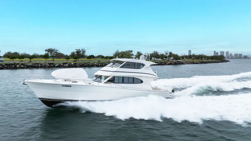 Unchained Freedom Yacht Photos Pics 2007 Maritimo M60 Cruising Motor Yacht speeding on water, clear sky background.