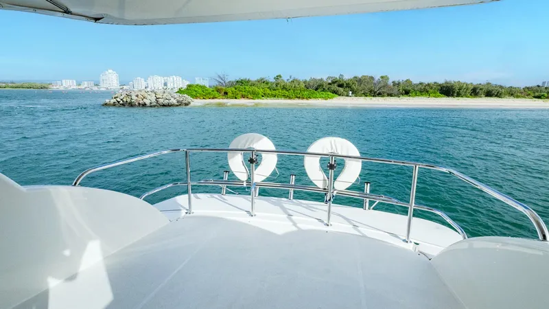 Unchained Freedom Yacht Photos Pics 2007 Maritimo M60 Cruising Motor Yacht deck with scenic ocean and island view.