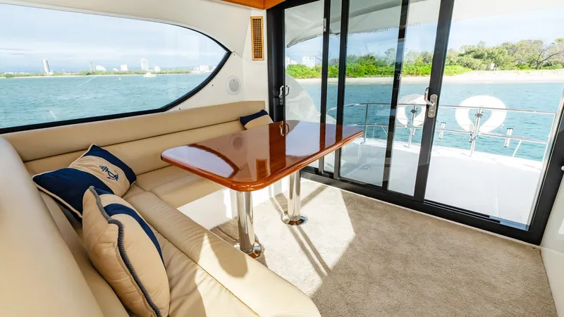 Unchained Freedom Yacht Photos Pics Interior of 2007 Maritimo M60 yacht with elegant seating and ocean view.