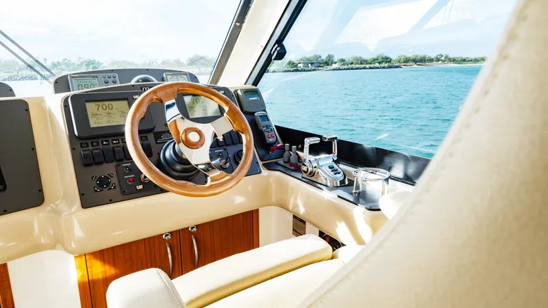 Unchained Freedom Yacht Photos Pics 2007 Maritimo M60 Cruising Motor Yacht helm with steering wheel and navigation controls.