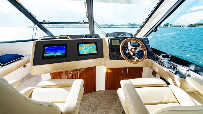 Unchained Freedom Yacht Photos Pics Luxurious helm of 2007 Maritimo M60 Cruising Motor Yacht with navigation screens and leather seating.