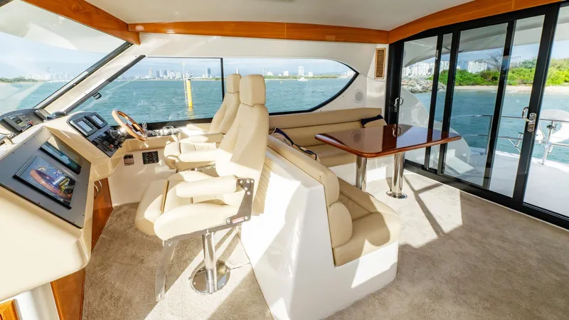 Unchained Freedom Yacht Photos Pics Luxurious interior of 2007 Maritimo M60 Cruising Motor Yacht with panoramic windows and plush seating.