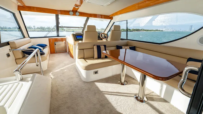 Unchained Freedom Yacht Photos Pics Luxurious interior of 2007 Maritimo M60 Cruising Motor Yacht with elegant seating and panoramic windows.