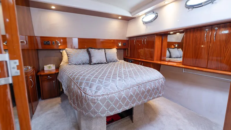 Unchained Freedom Yacht Photos Pics Luxurious bedroom interior of 2007 Maritimo M60 Cruising Motor Yacht with elegant wood finishes.